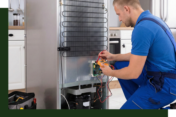 repair tech working on back of fridge