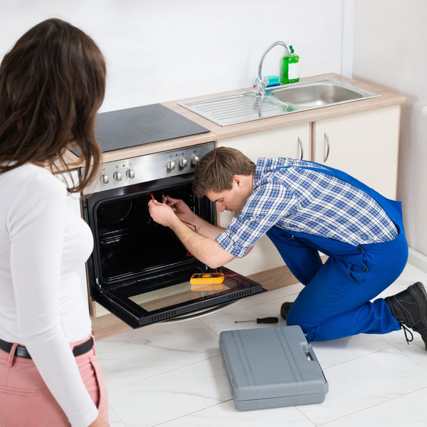 A tech fixing an oven