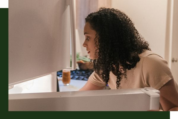 woman looking in fridge