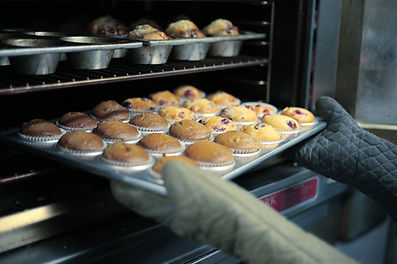 pulling muffins out of oven