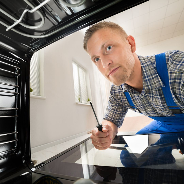Tech looking inside an oven