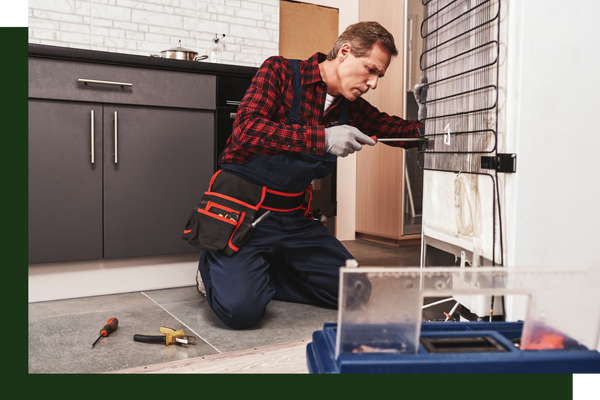 technician working on back of fridge