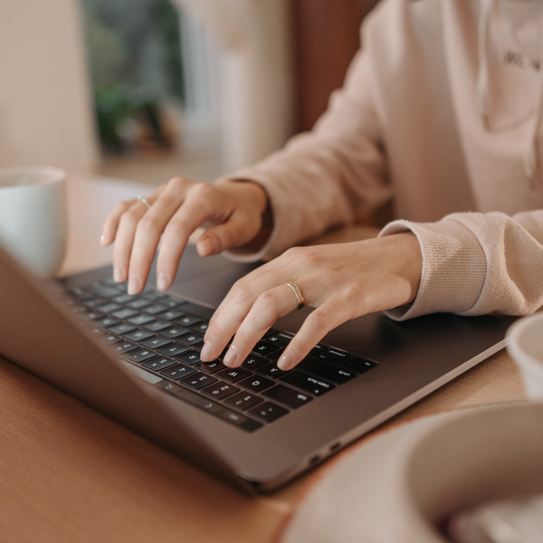 woman typing on laptop