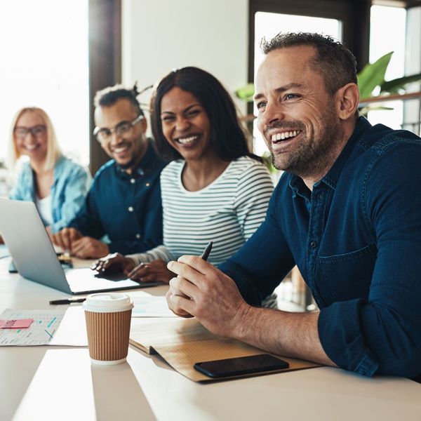 Office employees smiling and laughing while sitting together