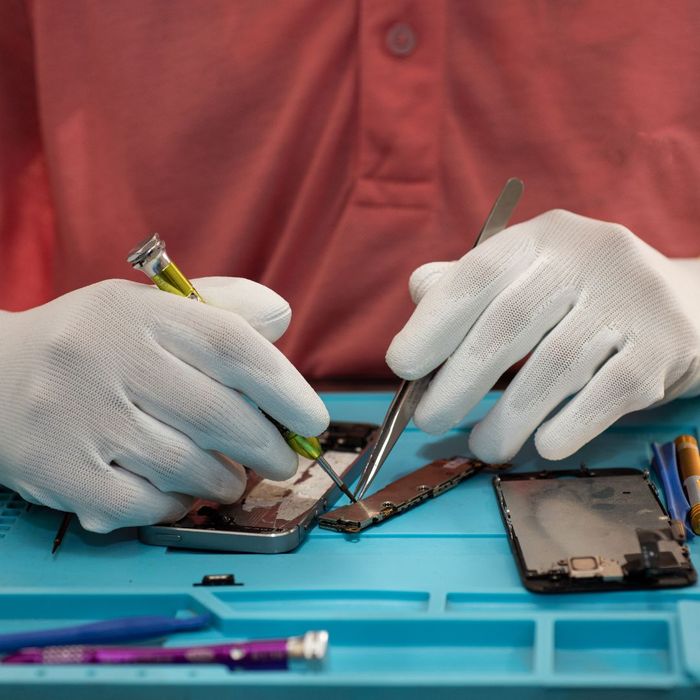 a worker repairing a phone