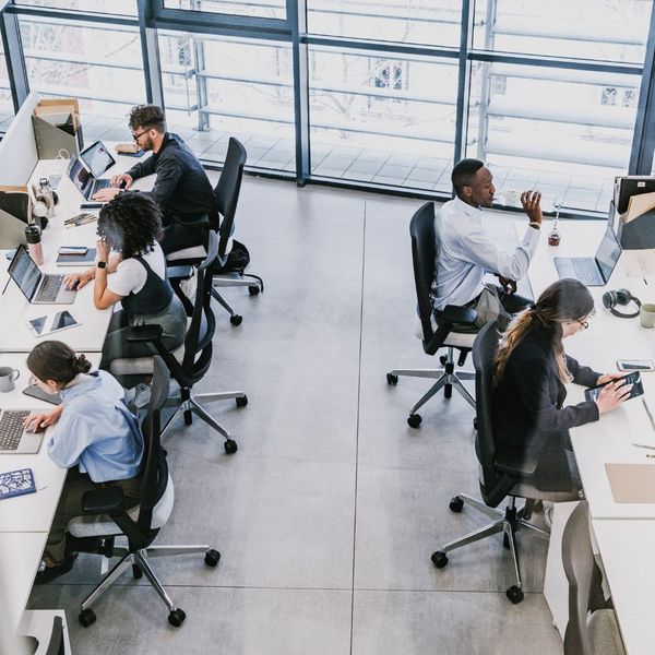 employees at desk in open workspace
