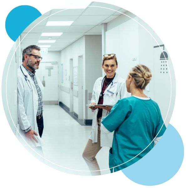 Hospital workers talking in a hallway