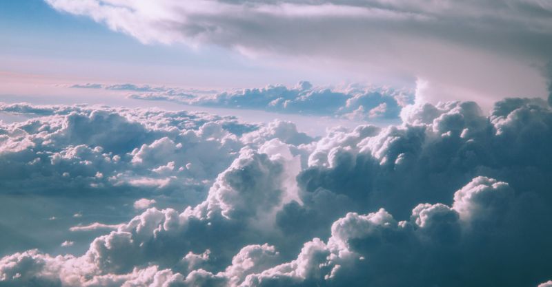 Fluffy clouds illuminated by soft sunlight in the sky