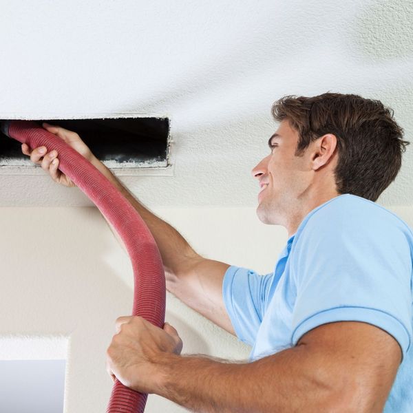 man cleaning air ducts. 