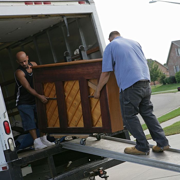 Movers moving a piano. 