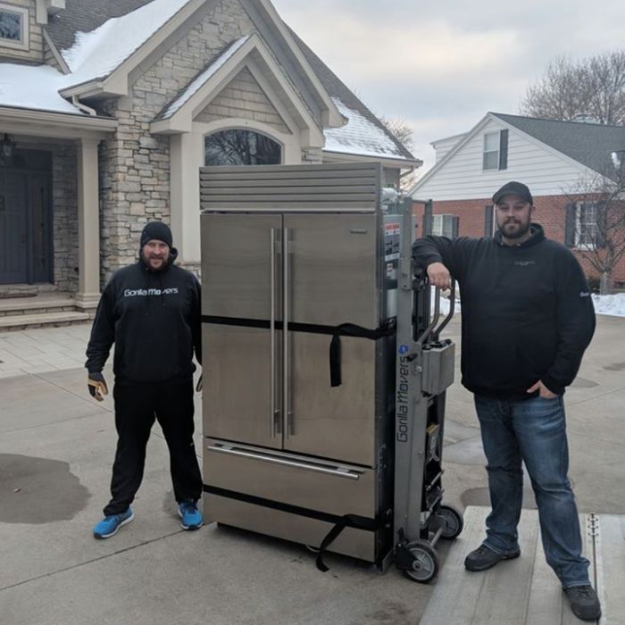 professional movers moving large fridge