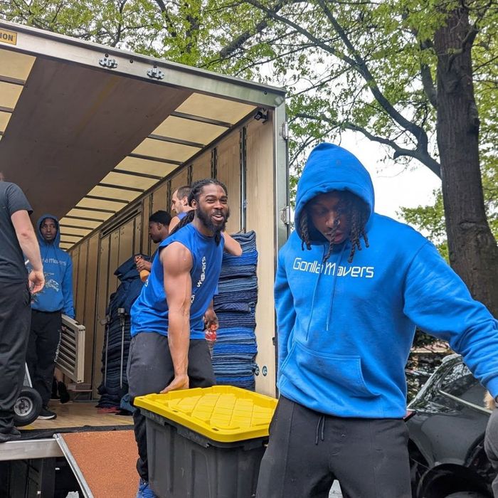 movers moving boxes out of van