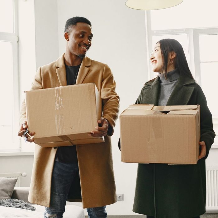 couple holding moving boxes couple holding moving boxes