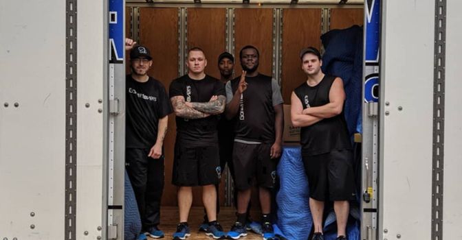 professional movers standing on truck