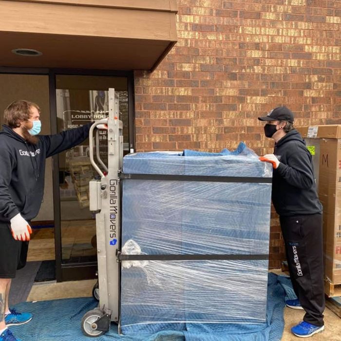 movers moving a large piece of equipment