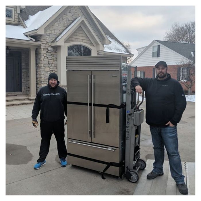 men moving fridge