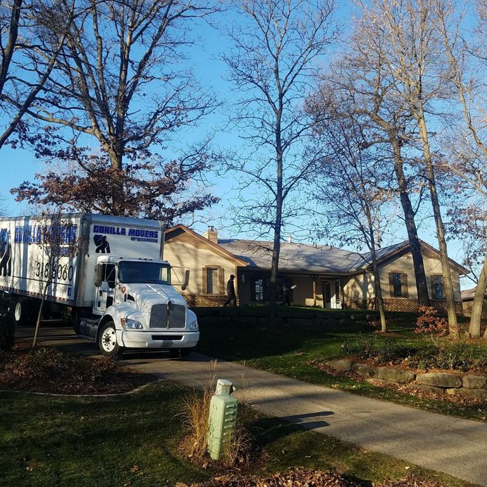 Moving truck in front of house 