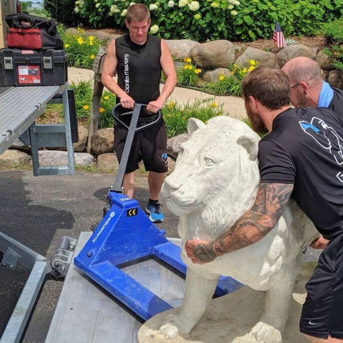 movers moving lion statue