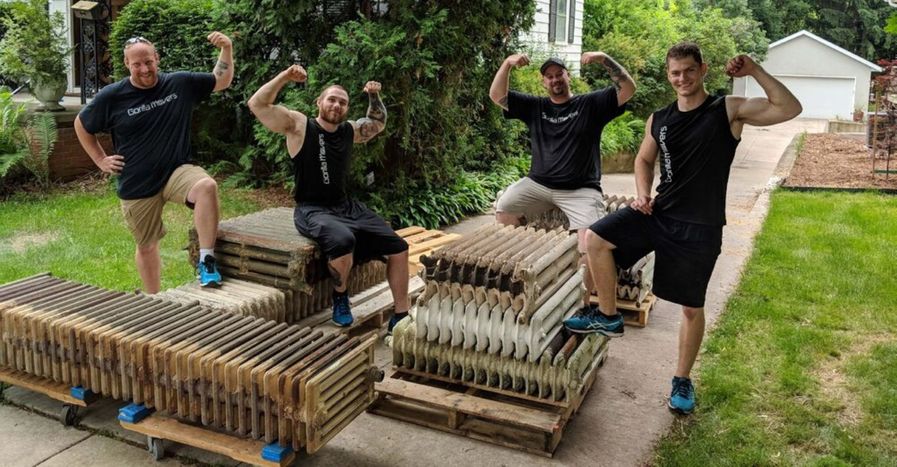 Gorilla Movers posing in front of heaters they are moving
