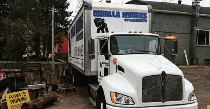 Gorilla Movers truck parked near "Private Parking" sign