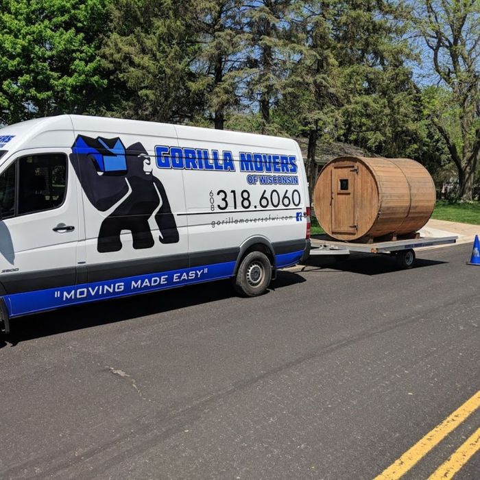 moving van pulling a small building