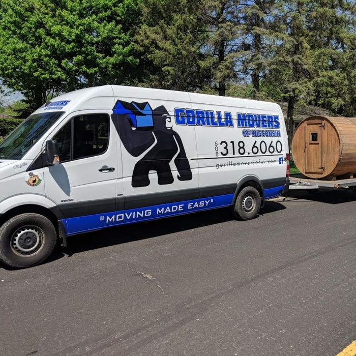 Gorilla Movers van towing a wooden barrel on trailer