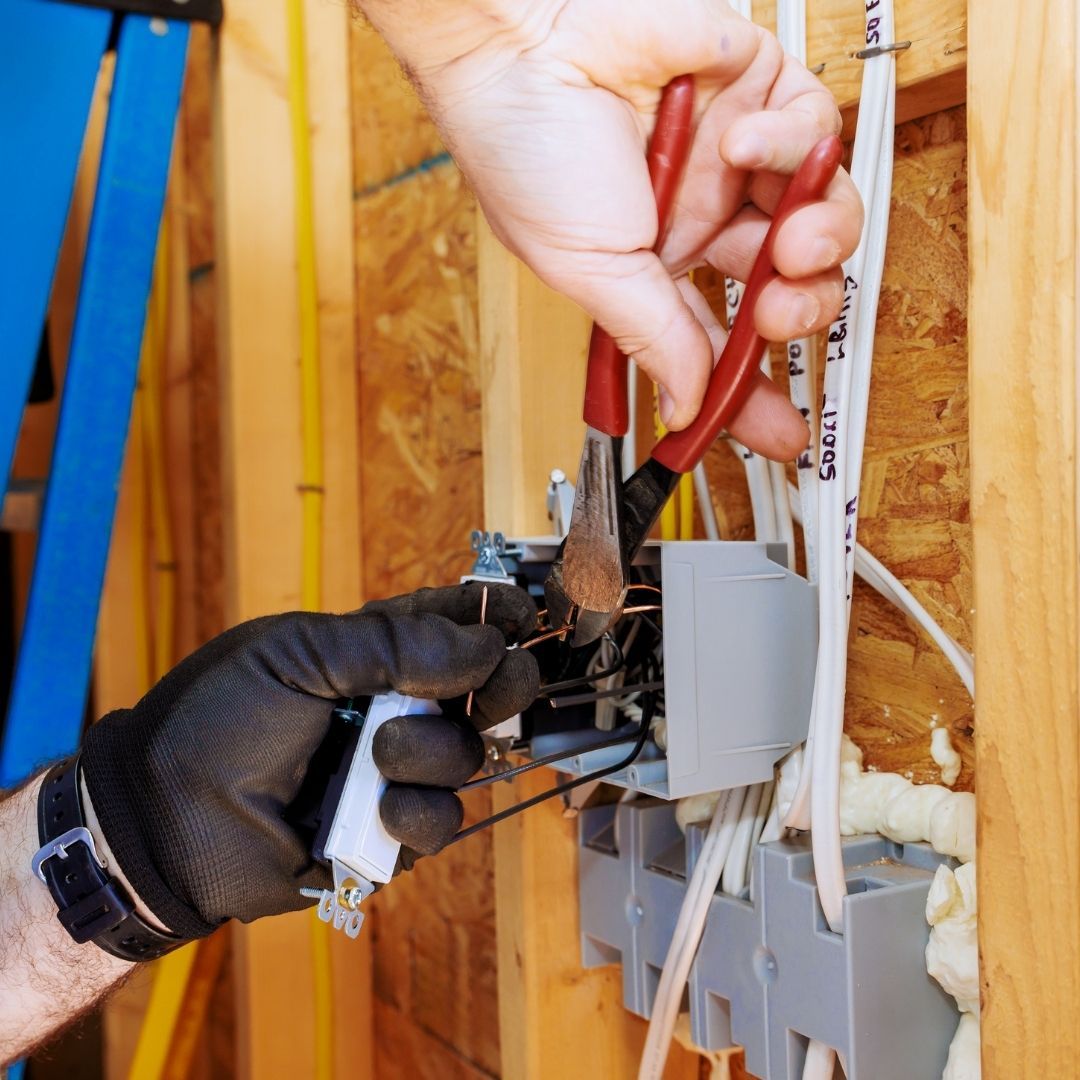 Electrician working on wiring in new construction