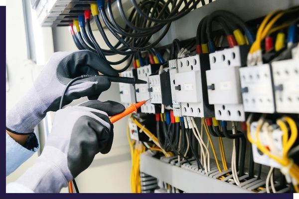 electrician testing wiring panel