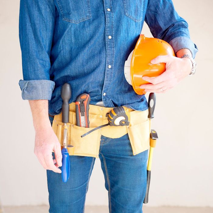 a handy man with a tool belt and safety helmet