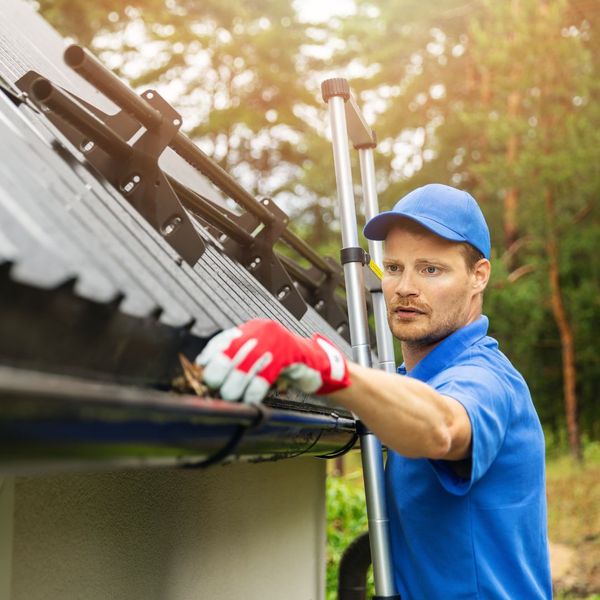 person inspecting gutters