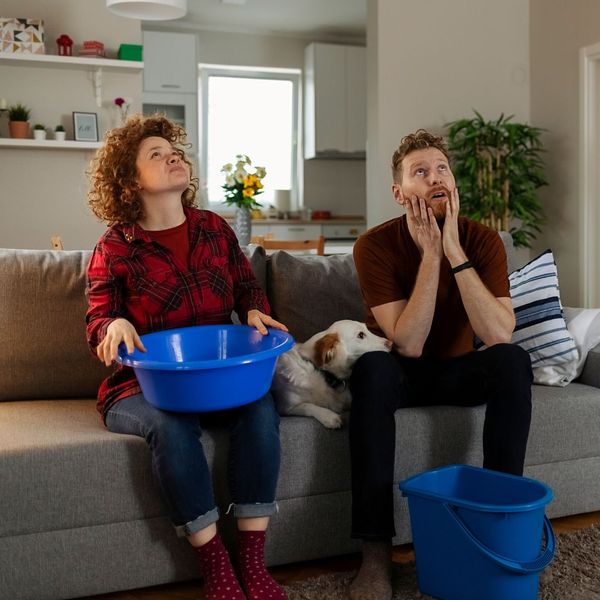 people with buckets in living room
