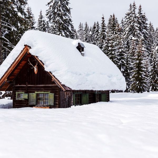 small cabin covered in snow