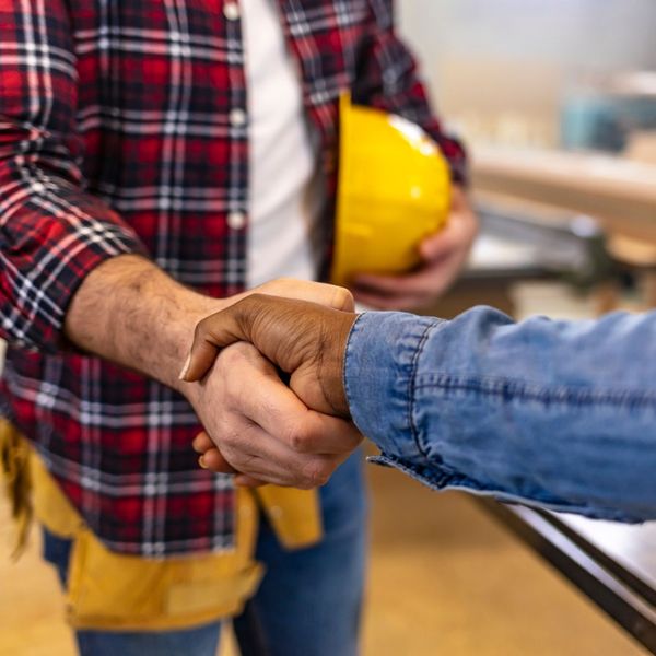 roofing contractor and client shaking hands