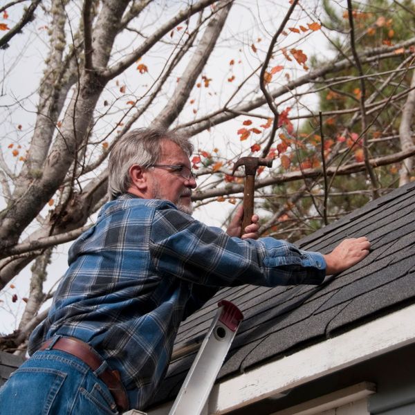 person examining roof