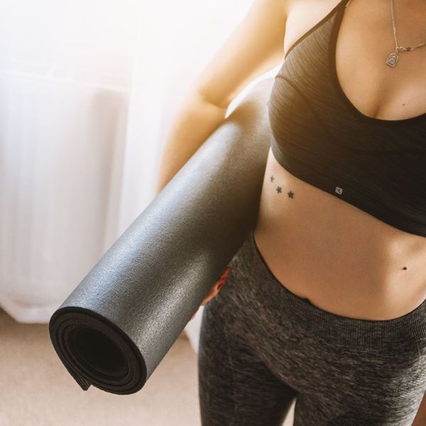Fit woman with yoga mat