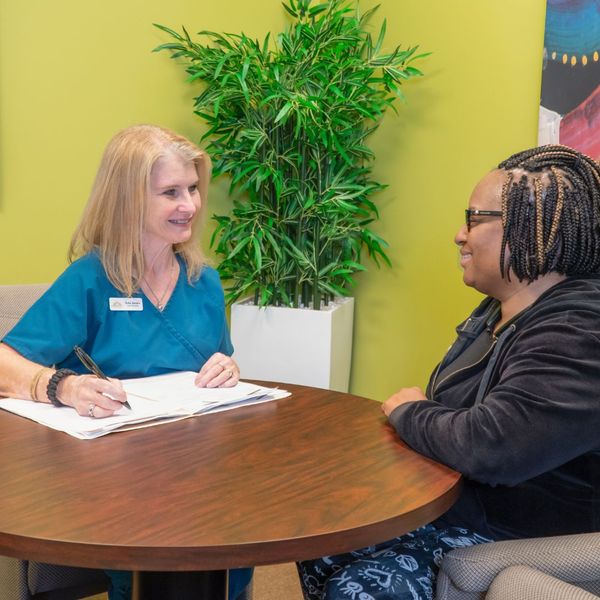 Multi-Care professional talking with patient Multi-Care professional talking with patient