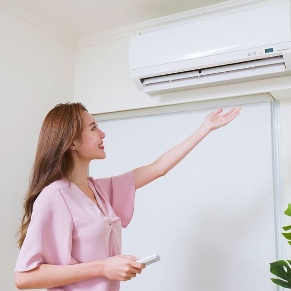 woman looking at AC unit