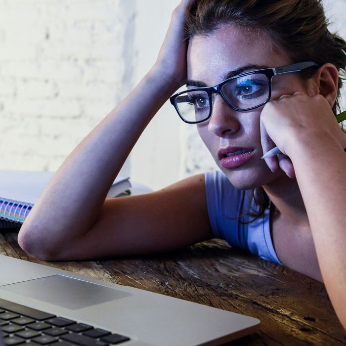 woman leans on table and resting head on hands How Does Stress Influence Gum Disease 2.jpg