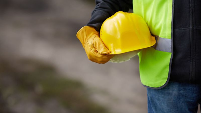 Worker holding hard hat
