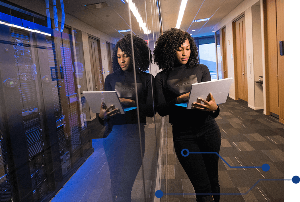 Woman leaning against glass wall of data center