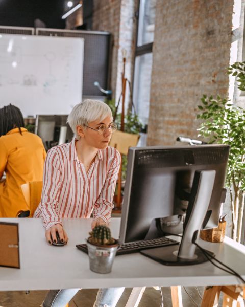 employee working on computer next to plants