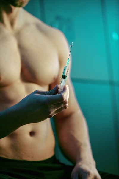 close-up-muscular-build-man-with-injection-anabolic-steroids-gym-s-changing-room.jpg