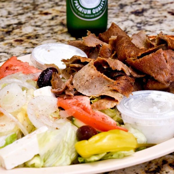 gyro meat on  a plate with a salad