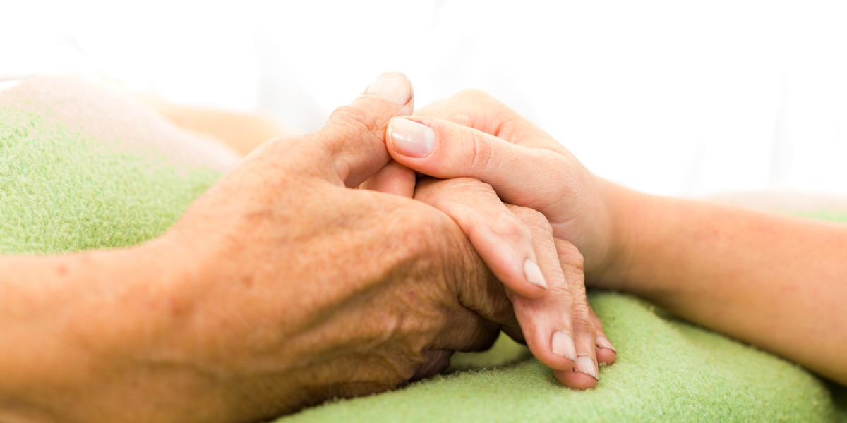 Younger hand holding an older hand