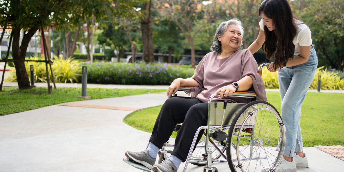 pushing woman in wheelchair