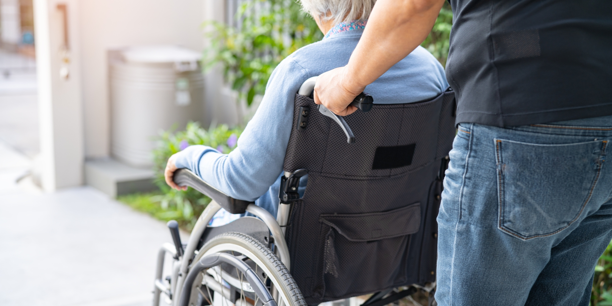 pushing man in wheelchair