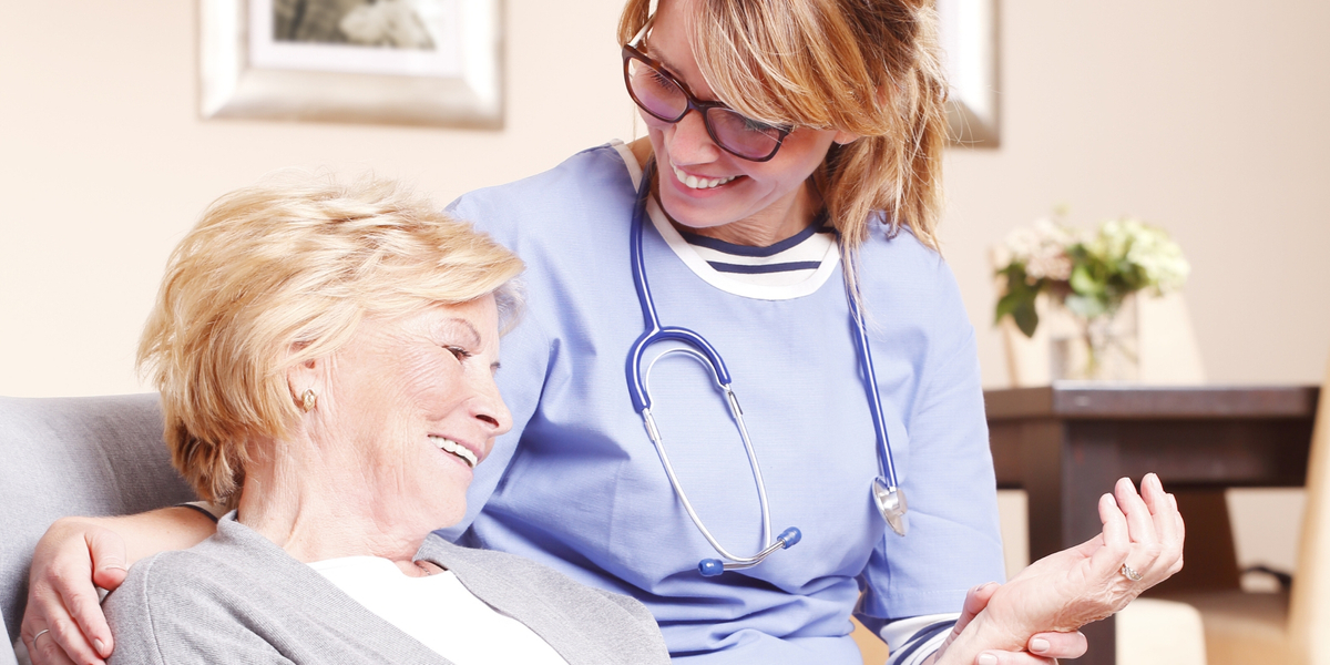 Caregiver sitting with a senior woman