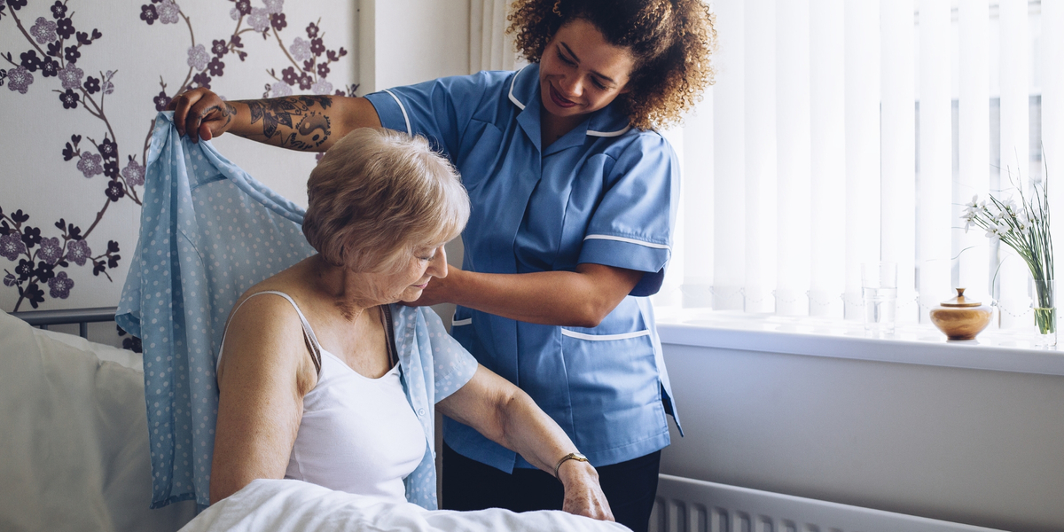 woman helping elderly woman