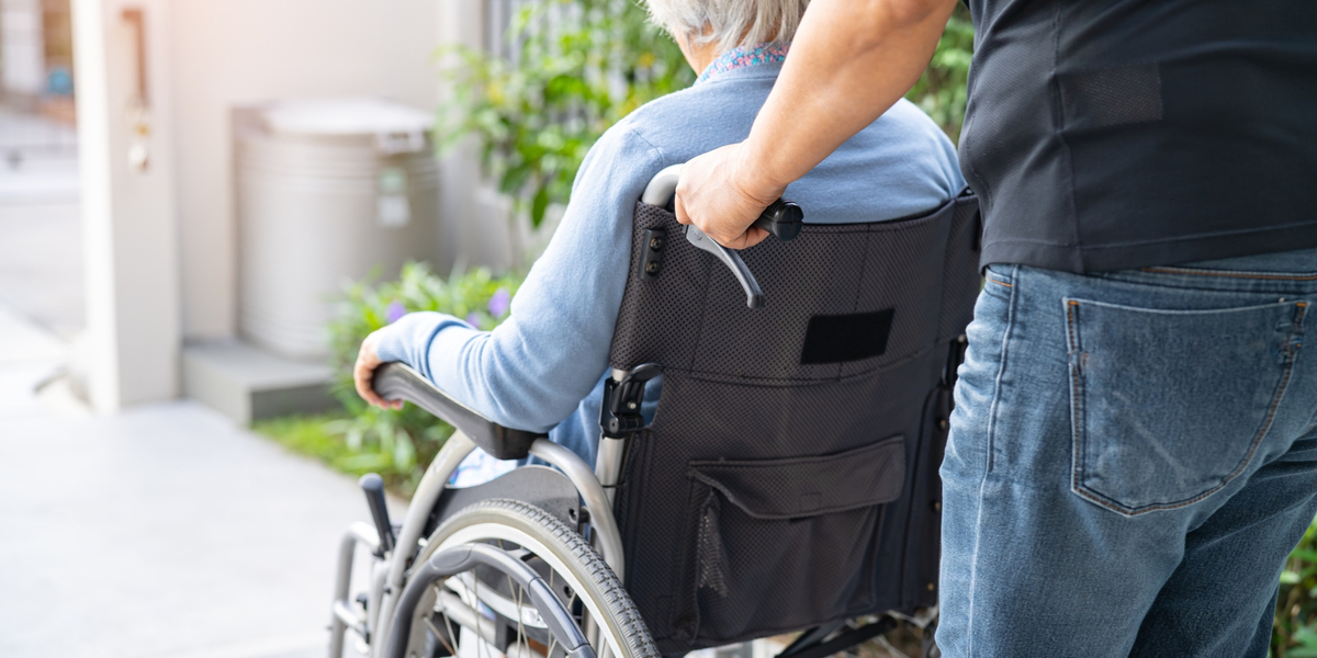 Caregiver helping a woman in a wheelchair