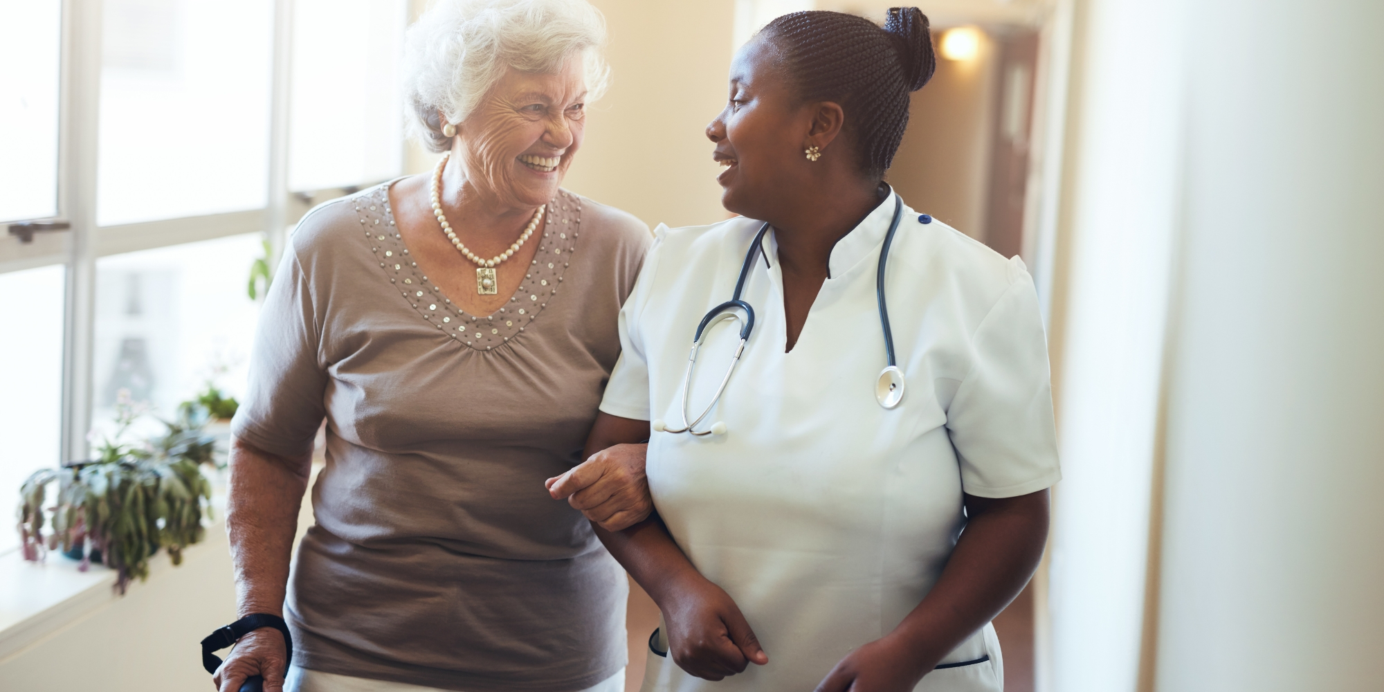 woman helping elderly woman